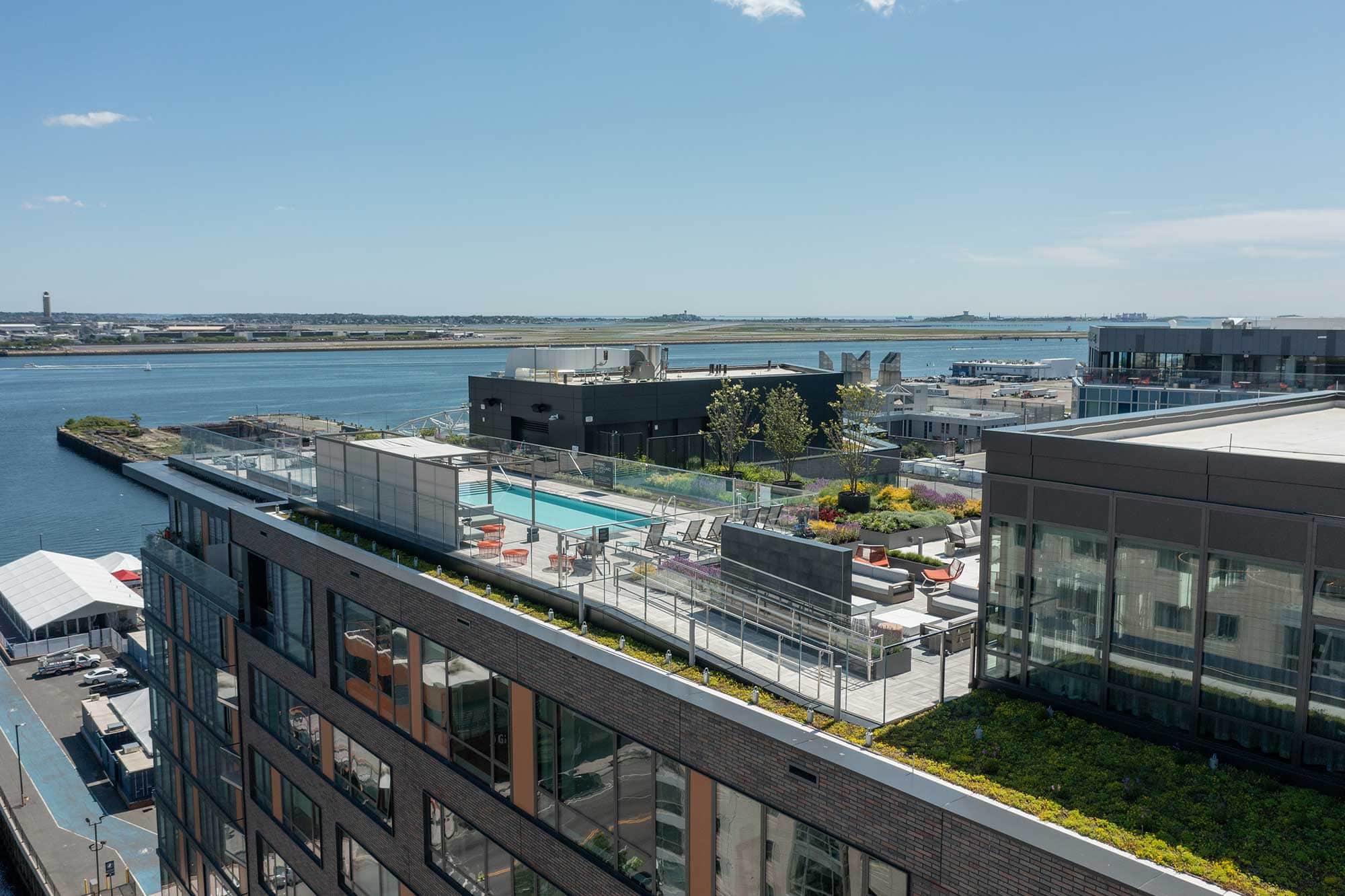 Ora Seaport Boston rooftop harbor panorama - luxury rental amenities Seaport District